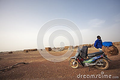 Black African migrant traveling in Mali towards Europe on his sc Editorial Stock Photo