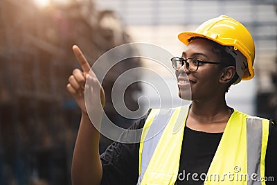 Black African smart women engineer worker finger point counting stock in factory industry warehouse proud smiling Stock Photo