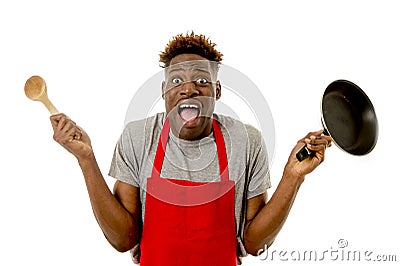 Black afro american man home cook in chef apron cooking pan and spoon lost and overworked Stock Photo