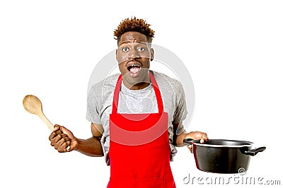 Black afro american man home cook in chef apron cooking pot and Stock Photo
