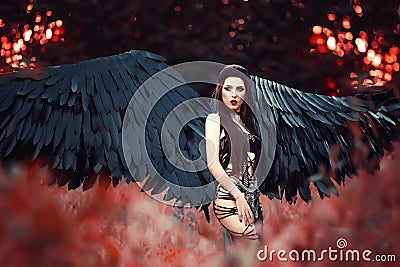 Black Angel. Pretty girl-demon Stock Photo