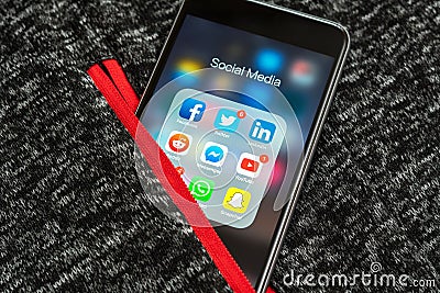 Black Apple iPhone with icons of social media: instagram, youtube, reddit, facebook, twitter, snapchat, whatsapp applications on s Editorial Stock Photo