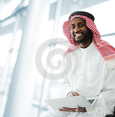 Black Arabic man working on laptop Stock Photo