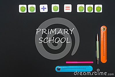Black art table with stationery supplies with text primary school on blackboard Stock Photo