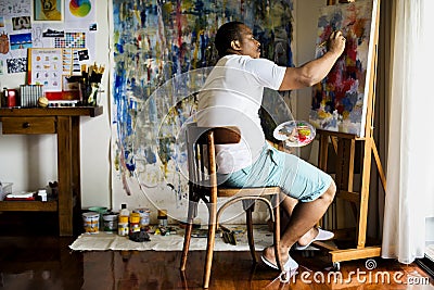 Black artist man doing his art work Stock Photo