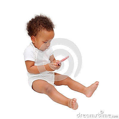 Black baby playing with mobile phone. Stock Photo