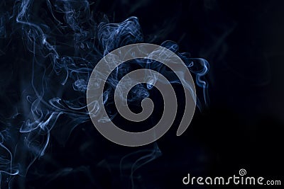 black background, blue smoke coming out, close-up Stock Photo