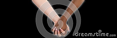 Two hands in a heartfelt embrace and a glow shining around them. Handshake. Two women holding hands. Two hands of Stock Photo