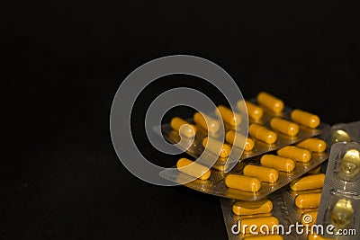 On black background lies tablets, medical mask, syringe, medicines. Coronavirus 19. Stock Photo