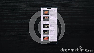 Black background on which you can see the hand that makes an order via the online store using a mobile device, ordering I write wi Editorial Stock Photo