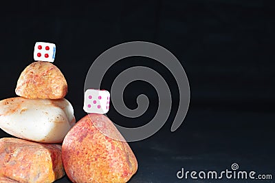 black backgrouund and stone Cairns,dice Stock Photo