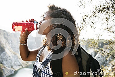 Black backpacker woman drinking water Stock Photo