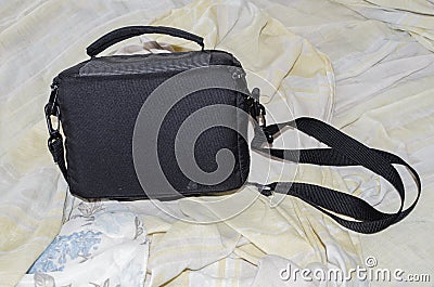 Black Bag On Unmade Bed Stock Photo