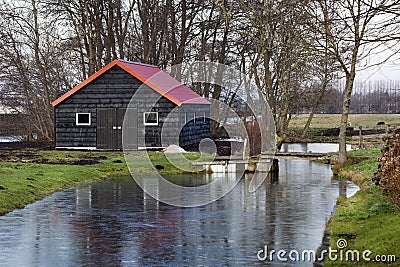 Black barn with a red roof Stock Photo