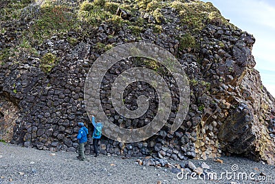 Black basalt cliffs sub-vertical polygonal columns and columnar joints Stock Photo