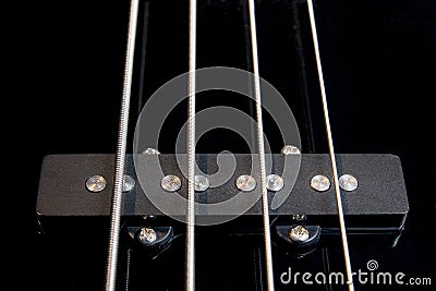 Black bass guitar pickup with strained strings Stock Photo