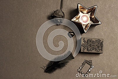 Black bird feathers and black glass heart. Stock Photo