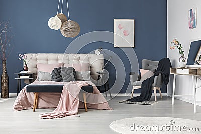 Black blanket on grey armchair Stock Photo