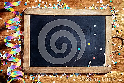 Black Board on Table with Streamers and Confetti Stock Photo