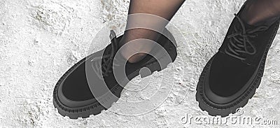 Black boots on woman legs, urban fashion concept, banner background photo Stock Photo