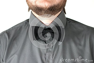 Black bow-tie with gray shirt on men's neck. Stock Photo