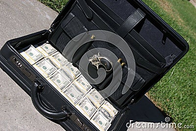 Black briefcase full of cash Stock Photo