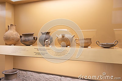 Black burnished jar, bowl, terracotta whorl and other pieces of ancient greek culture in a museum Editorial Stock Photo