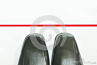 Black business leather shoe with red line to transcend on white background Stock Photo