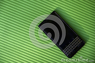 Black business smartphone on green background Stock Photo