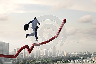 Black businessman running on red increasing arrow Stock Photo