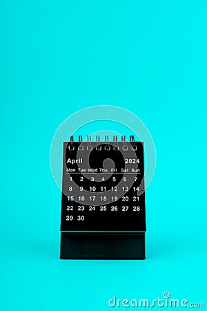 Black Calendar for April 2024. Desktop calendar on a green background Stock Photo