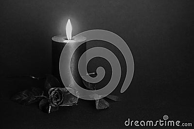 Black candle, black rose, glass heart. Stock Photo