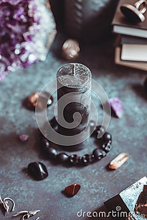 Black candle on a witch`s altar for a magical ritual Stock Photo