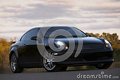 Black car with its headlights on Stock Photo