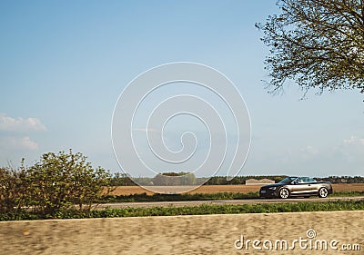 Black carbon Audi Convertible car driving fast Editorial Stock Photo