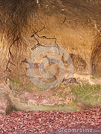 Black carbon paint of human hunting on sandstone wall, copy of prehistoric picture. Abstract children art in cave Stock Photo