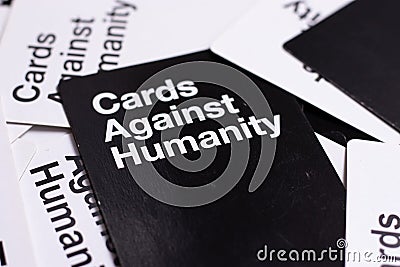 Black cards against humanity card viewed at an angle, flat lay of many cards on the table Editorial Stock Photo