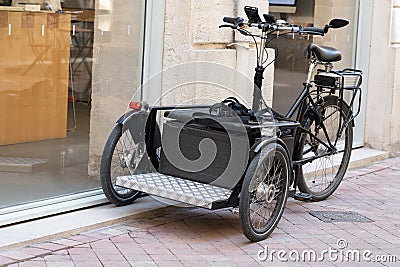 Black cargo bike bicycle basket modern fashion city street urban transportation Editorial Stock Photo