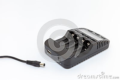 Black charger for AA and AAA batteries with unplugged cable. Stock Photo