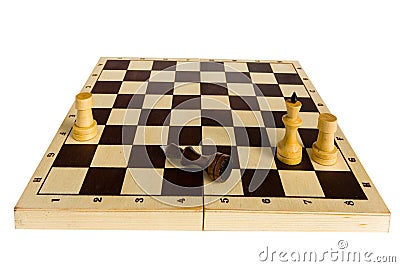 The black chess king is defeated and lies on the board. Stock Photo