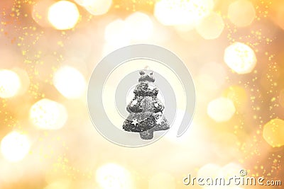 Black christma tree outline on yellow, gold, and white color bokeh background. Stock Photo