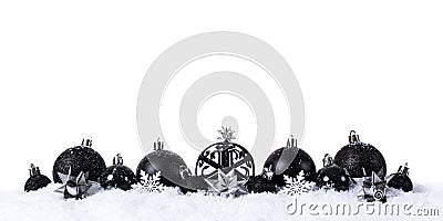 Black christmas balls with snow on white background Stock Photo
