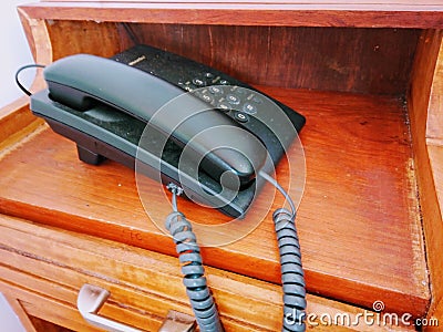 Black clasic telephone on wooden desk Stock Photo