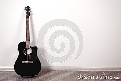 Black Classical Acoustic Guitar in an Empty Room with Copy Space Stock Photo