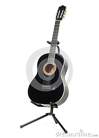 Black classical guitar on a guitar stand Stock Photo