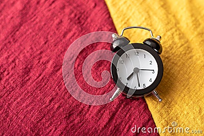 The black clock place on the red and yellow fabric Cartoon Illustration