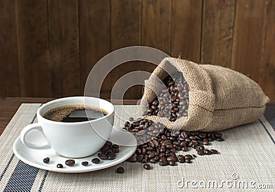Black coffee and sack of roasted coffee beans. Stock Photo