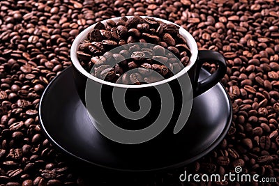 Black coffee cup filled with roasted beans background Stock Photo