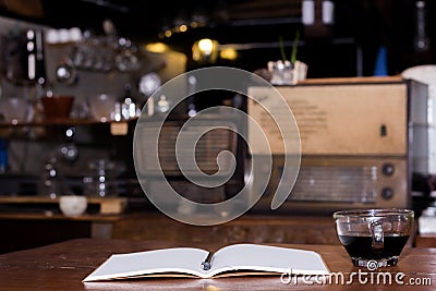 Black coffee cup and wooden desk diary Stock Photo