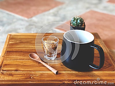 Black coffee cup with wooden spoon , green cactus , brown sugars Stock Photo